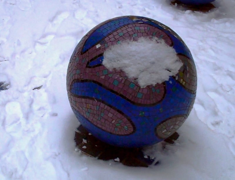 Concrete Broadmead Ball with blue mosaic tile design covered in snow